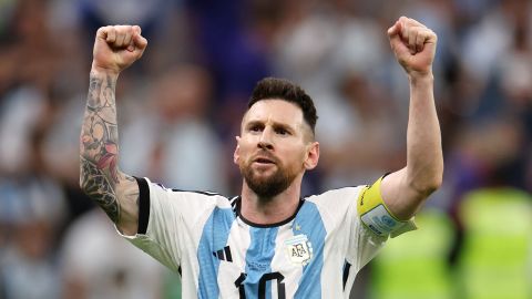 Lionel Messi Confirms Retirement After FIFA World Cup Qatar Final Game. He is rasing his both hands to cheer people and acknowledge their support during the match. He has tattoos all along his both hands.