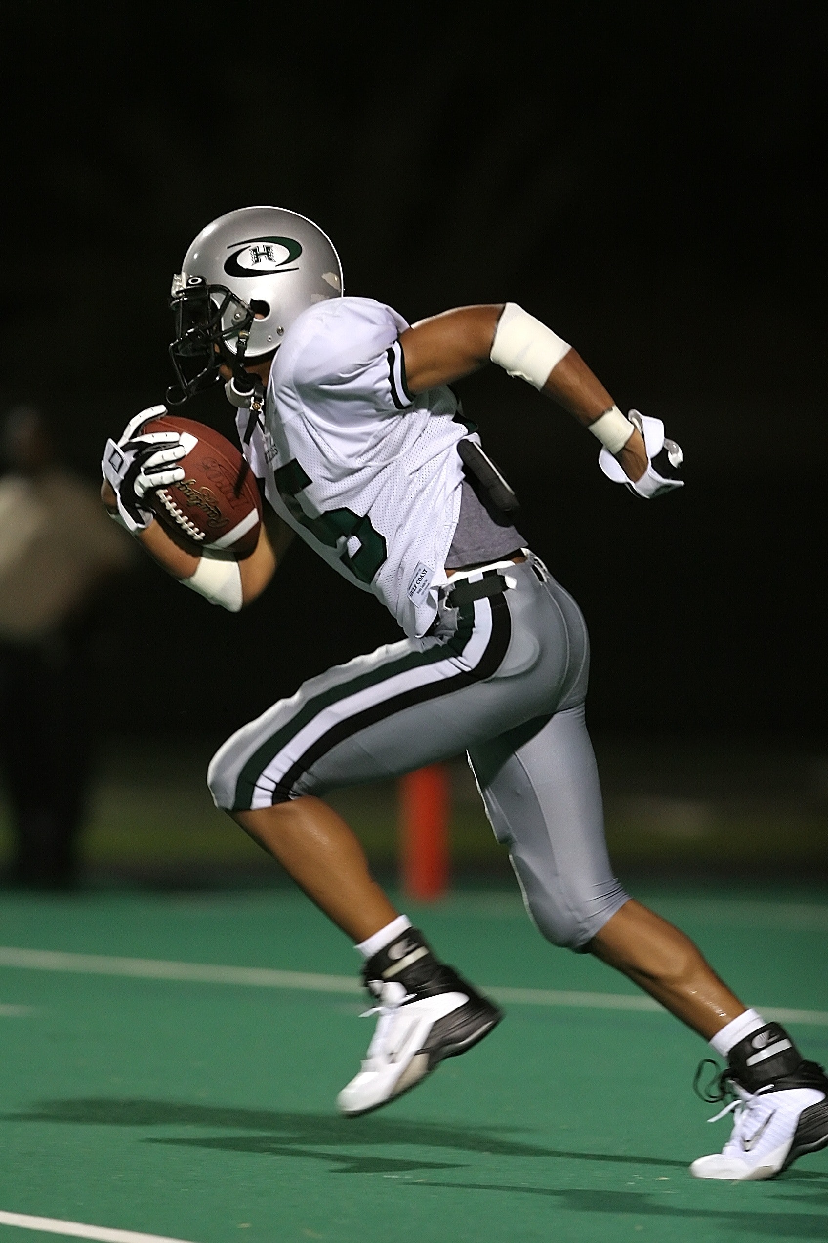 AN American football player running with the ball in his hand while taking part in the tournament