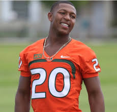 Photo of Ray Lewis III wearing an orange costume with the number 20 encripted in front. He looks cheering Remembering Ray Lewis III: Honoring a Life of Passion, Talent, and Legacy